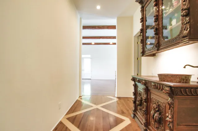 a living room with furniture hardwood floor and a window