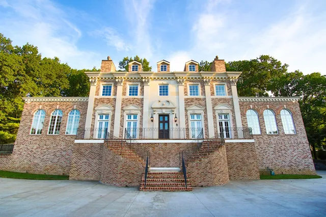 a front view of a residential apartment building with a yard