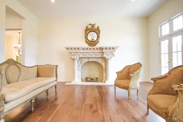 a living room with furniture a fireplace and a window