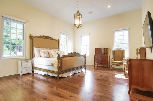 a bathroom with a granite countertop sink and a window