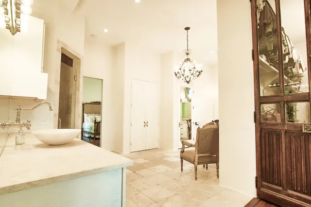 a view of a living room with entryway and wooden floor