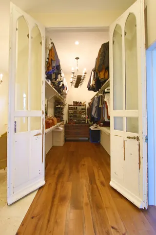a living room with furniture and a large mirror