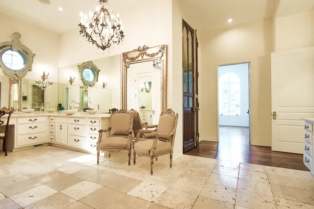 a living room with furniture and a large mirror