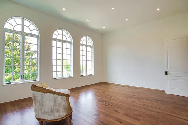 a spacious bedroom with a bed and a couch