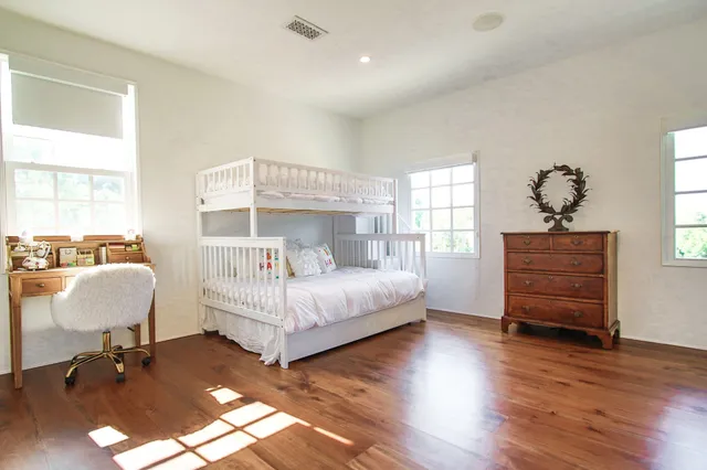 a bathroom with a granite countertop sink a mirror and shower