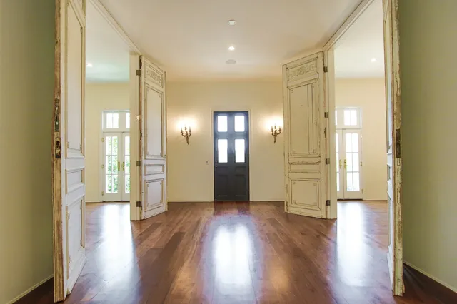 a view of a hallway with wooden floor