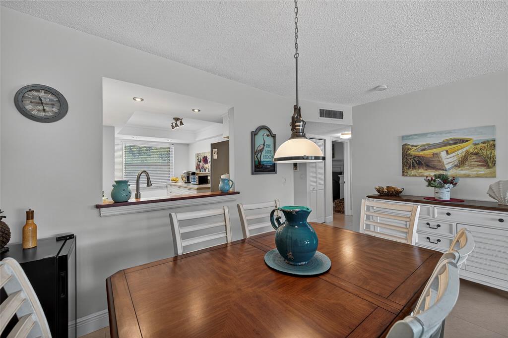 1550 Northwest 80th Avenue, Unit 303 Margate, FL 33063 - Photo 14 of 41 a kitchen with a table and chairs