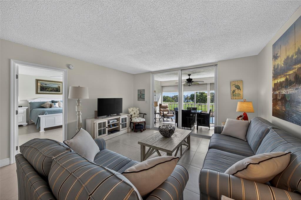 1550 Northwest 80th Avenue, Unit 303 Margate, FL 33063 - Photo 16 of 41 a living room with furniture and a flat screen tv