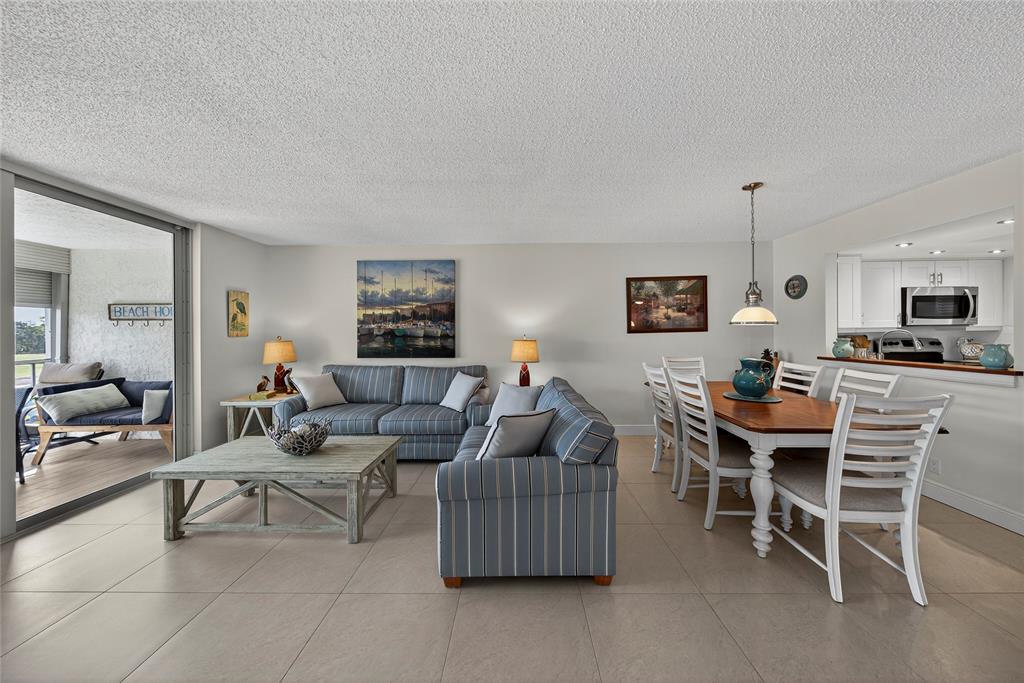 1550 Northwest 80th Avenue, Unit 303 Margate, FL 33063 - Photo 17 of 41 a living room with furniture and a table