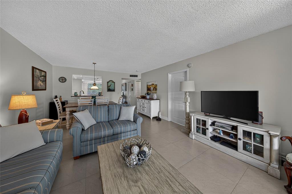 1550 Northwest 80th Avenue, Unit 303 Margate, FL 33063 - Photo 19 of 41 a living room with furniture and a flat screen tv