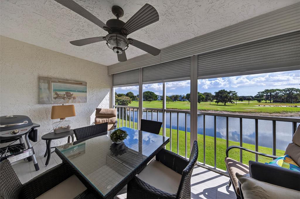 1550 Northwest 80th Avenue, Unit 303 Margate, FL 33063 - Photo 21 of 41 a living room with furniture and a floor to ceiling window