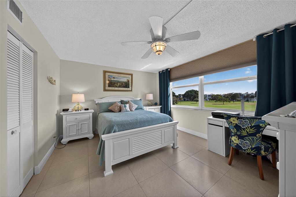 1550 Northwest 80th Avenue, Unit 303 Margate, FL 33063 - Photo 23 of 41 a spacious bedroom with a bed and a table
