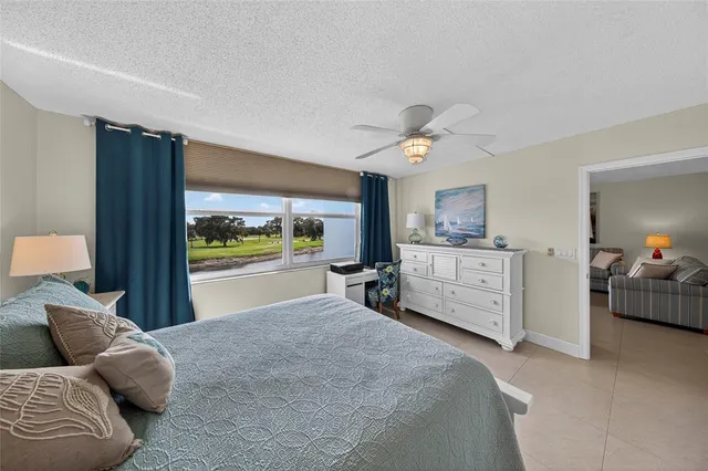 a bedroom with furniture and a large window