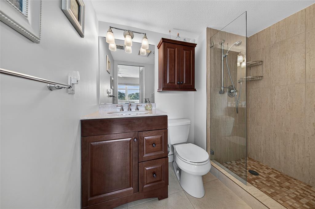 1550 Northwest 80th Avenue, Unit 303 Margate, FL 33063 - Photo 27 of 41 a bathroom with a sink a toilet and shower