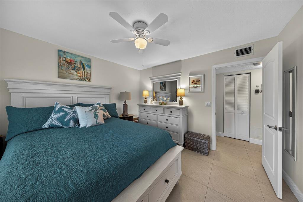 1550 Northwest 80th Avenue, Unit 303 Margate, FL 33063 - Photo 29 of 41 a bedroom with a bed and a chandelier