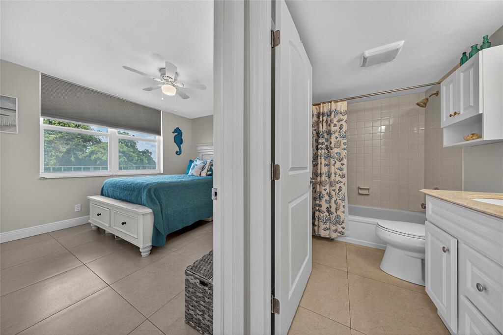 1550 Northwest 80th Avenue, Unit 303 Margate, FL 33063 - Photo 31 of 41 a spacious en suite bathroom with a double vanity sink a large mirror and a bathtub