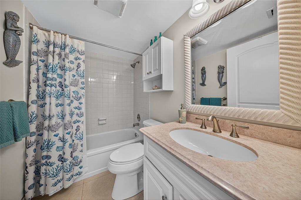 1550 Northwest 80th Avenue, Unit 303 Margate, FL 33063 - Photo 32 of 41 a bathroom with a granite countertop sink toilet and shower