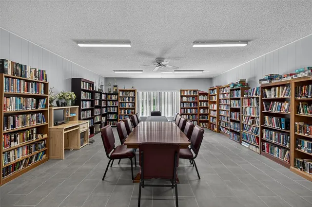 a view of a dining room with furniture and a bookshelf