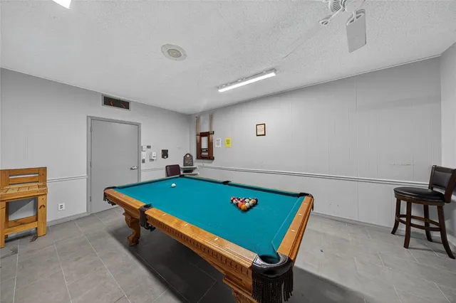 a room with furniture pool table and a rug