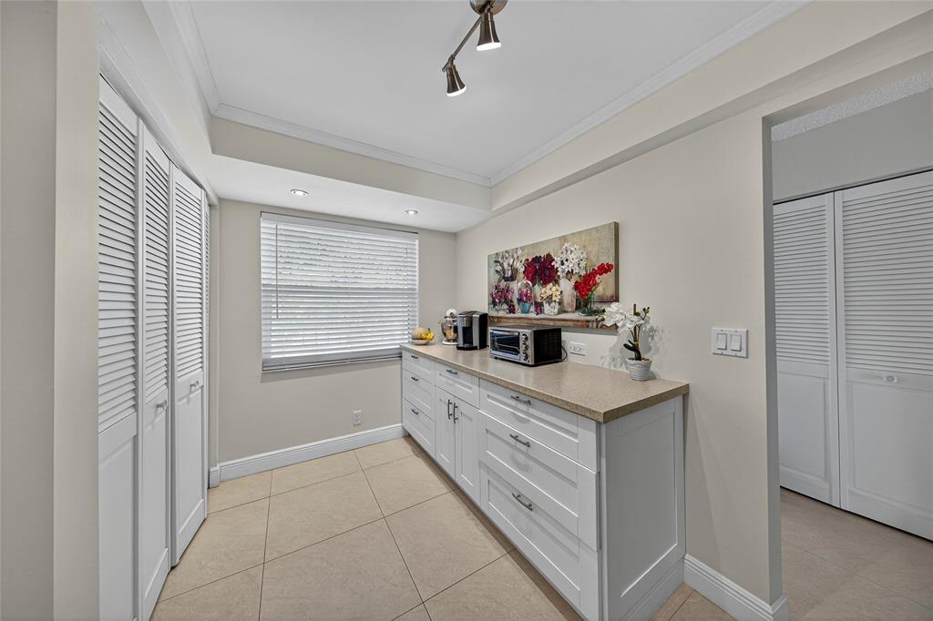 1550 Northwest 80th Avenue, Unit 303 Margate, FL 33063 - Photo 6 of 41 a kitchen with a cabinets and window