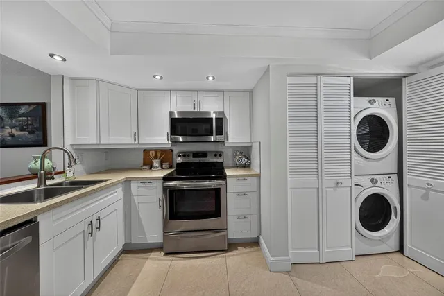 a kitchen with a stove top oven sink and cabinets
