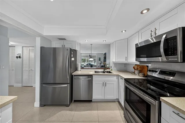 a kitchen with stainless steel appliances a refrigerator stove and microwave