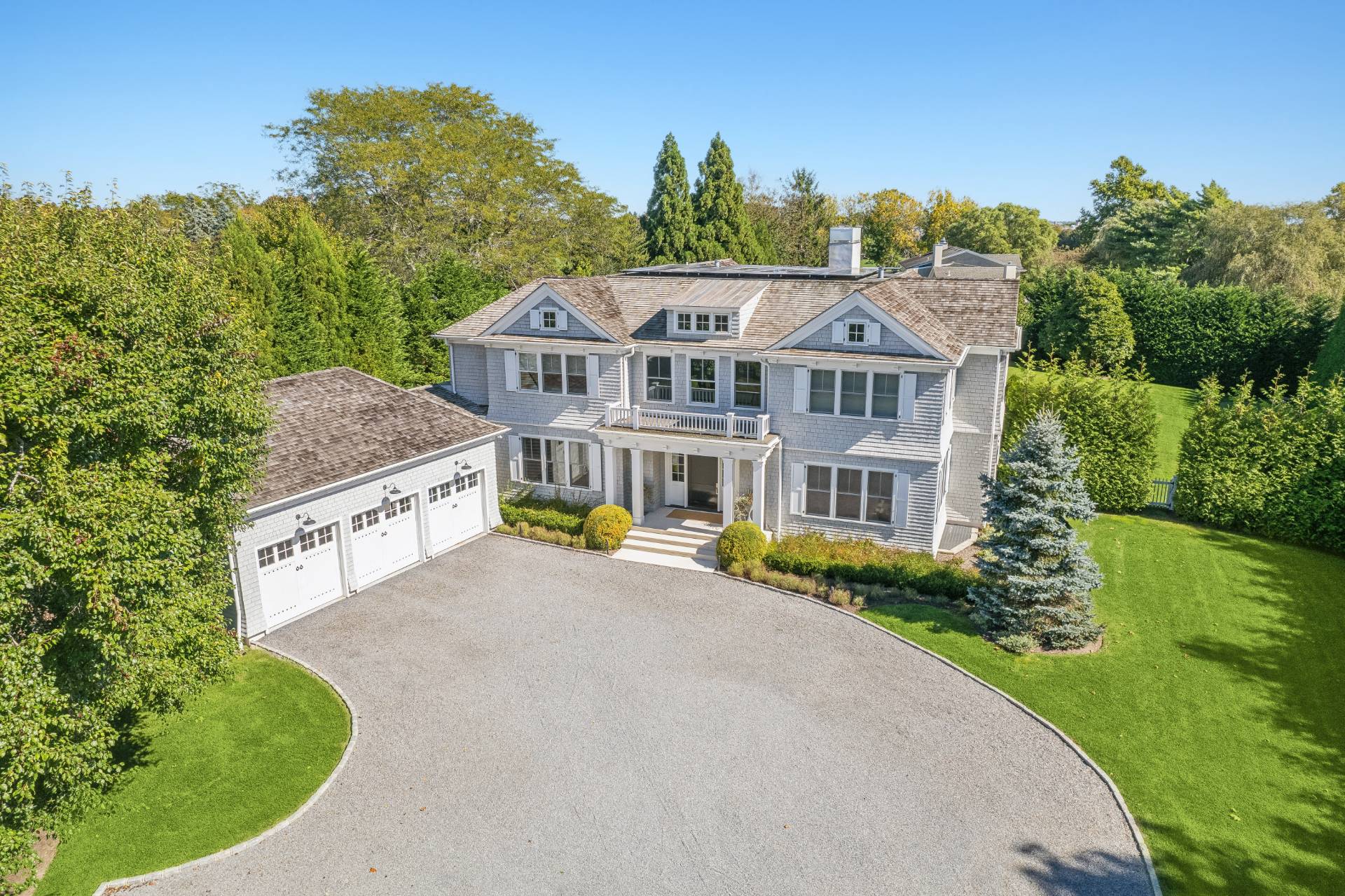 an aerial view of a house with a yard table and chairs