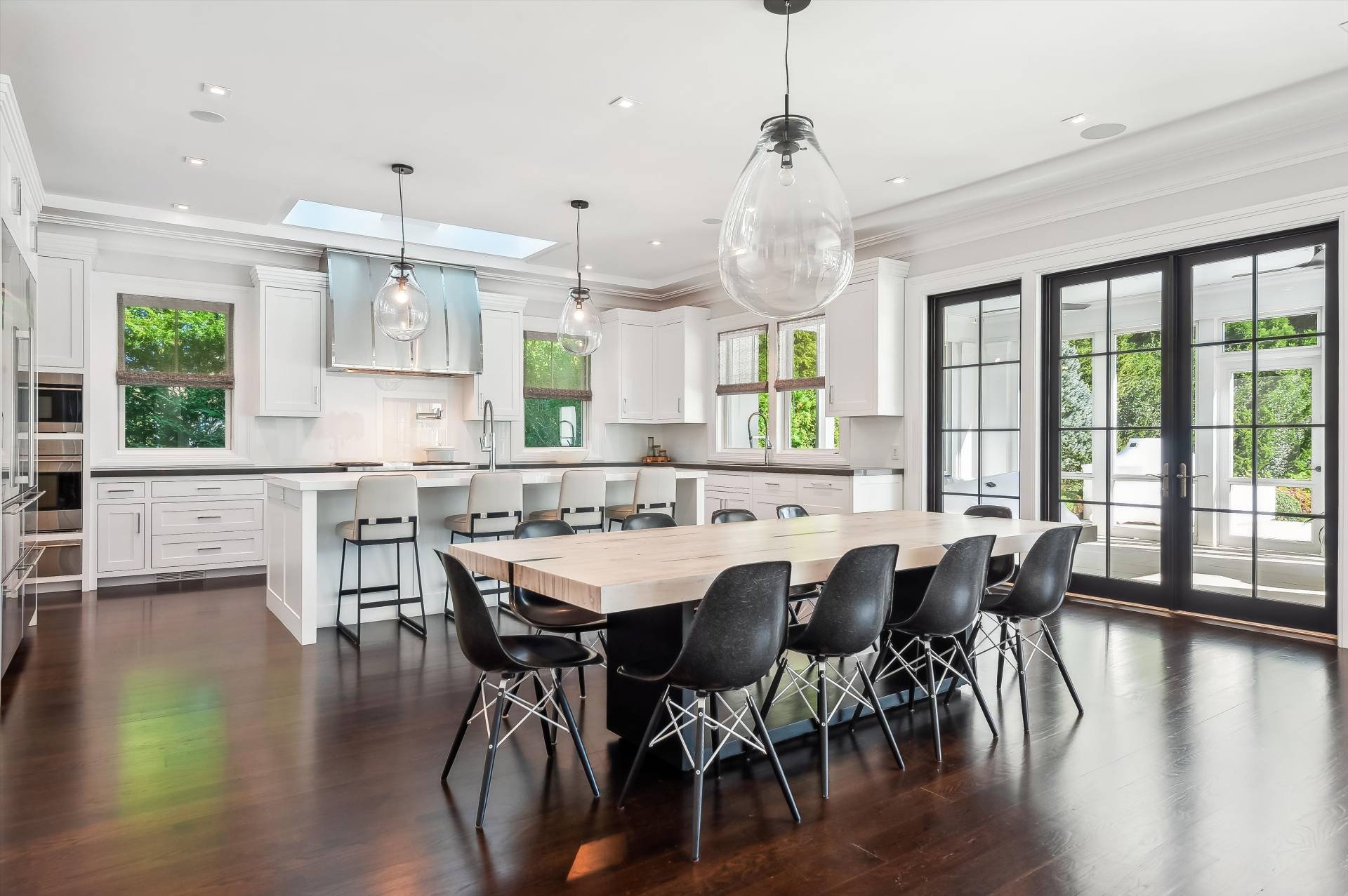 80 Cobb Road Water Mill, NY 11976 - Photo 8 of 35 a view of a dining room and livingroom with furniture wooden floor a chandelier