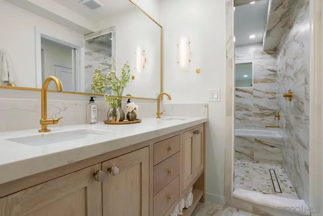 a bathroom with a sink a vanity and a mirror