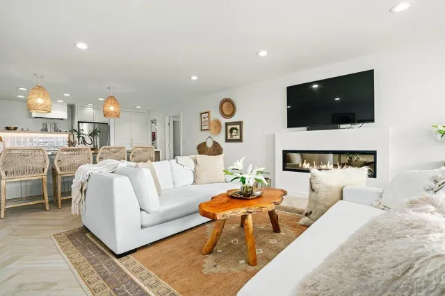 a living room with fireplace furniture and a flat screen tv