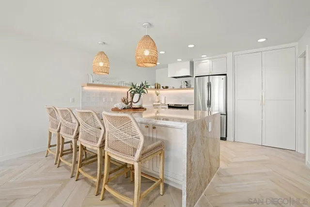 a kitchen with refrigerator and cabinets