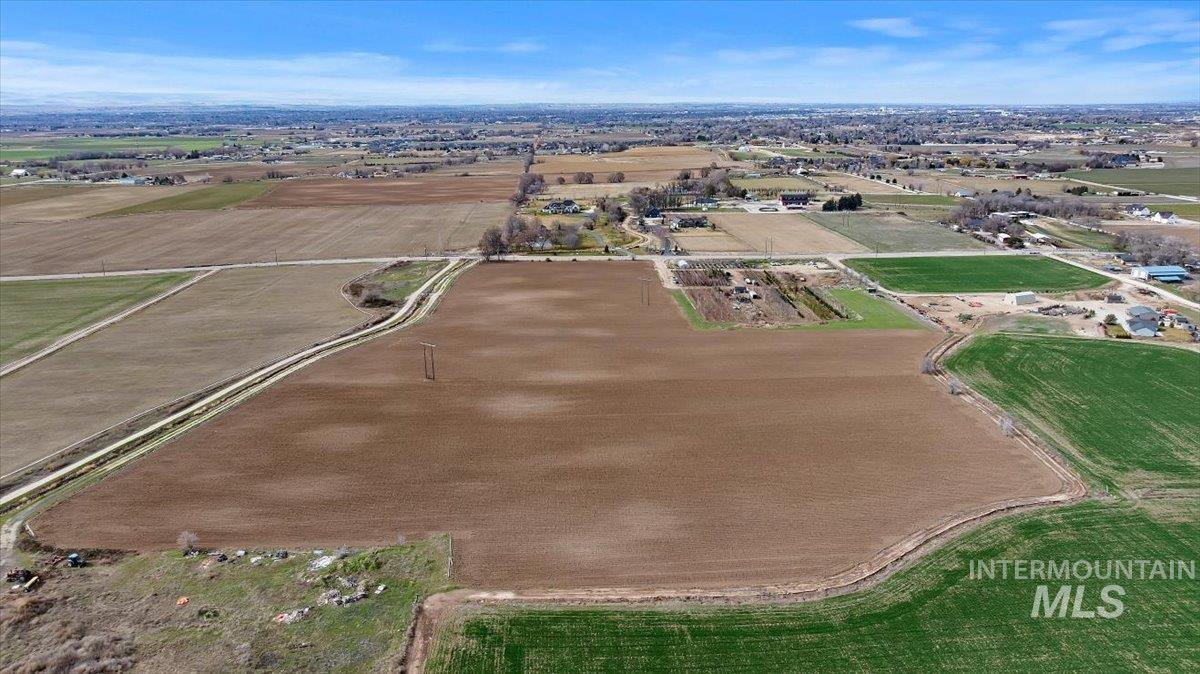 3850 South Black Cat Road Meridian, ID 83642 - Photo 4 of 7 Aerial view of property and surrounding area with rural landscape and abundant farmland