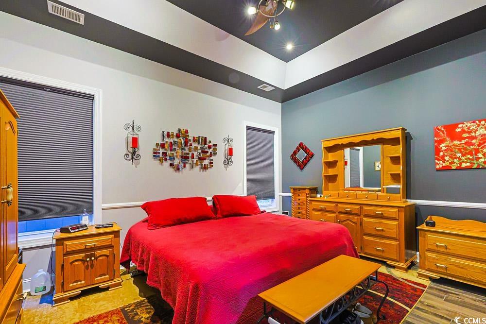 105 Rocko Drive Myrtle Beach, SC 29579 - Photo 12 of 38 Bedroom featuring a raised ceiling and ceiling fan