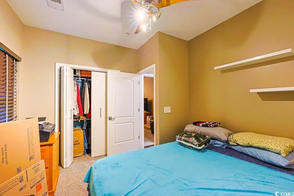 105 Rocko Drive Myrtle Beach, SC 29579 - Photo 21 of 38 Bedroom featuring a closet, light carpet, and a ceiling fan