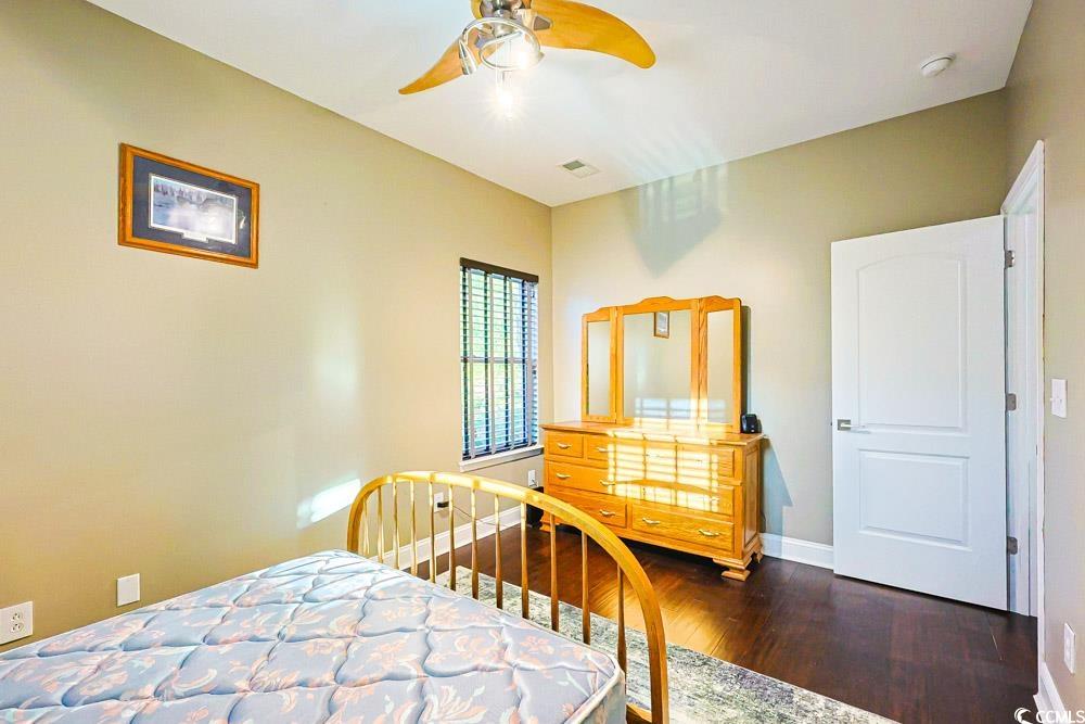 105 Rocko Drive Myrtle Beach, SC 29579 - Photo 25 of 38 Bedroom featuring dark wood-style flooring and a ceiling fan
