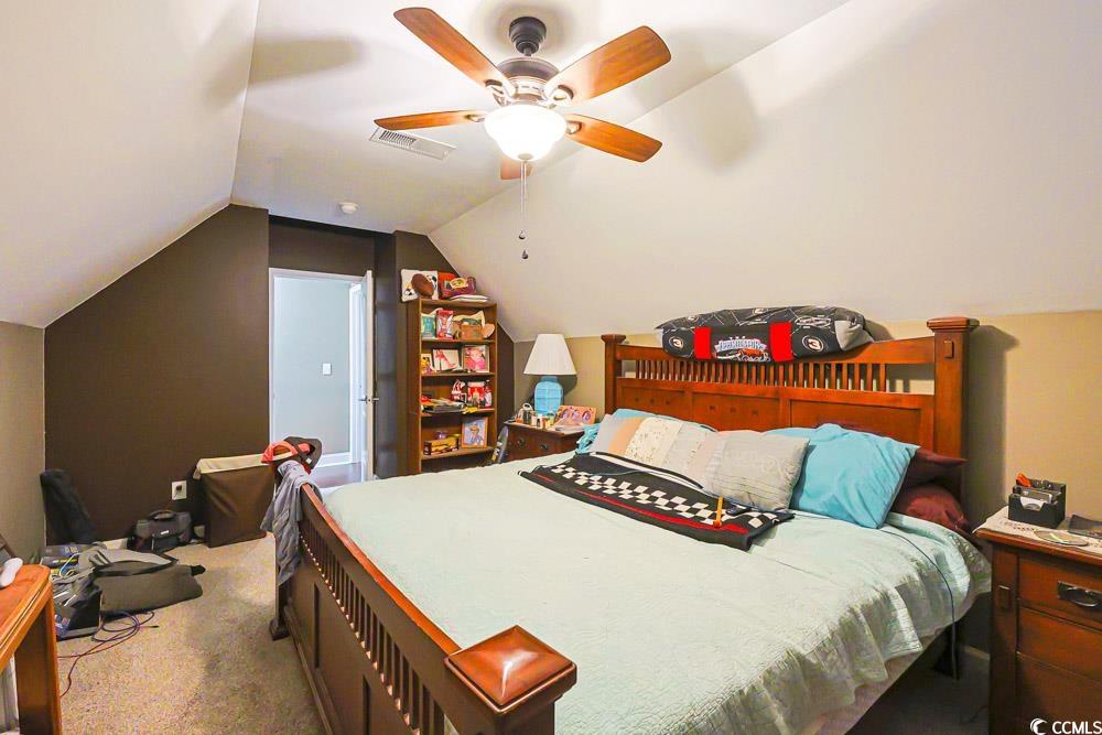 105 Rocko Drive Myrtle Beach, SC 29579 - Photo 29 of 38 Bedroom with vaulted ceiling, ceiling fan, and light colored carpet