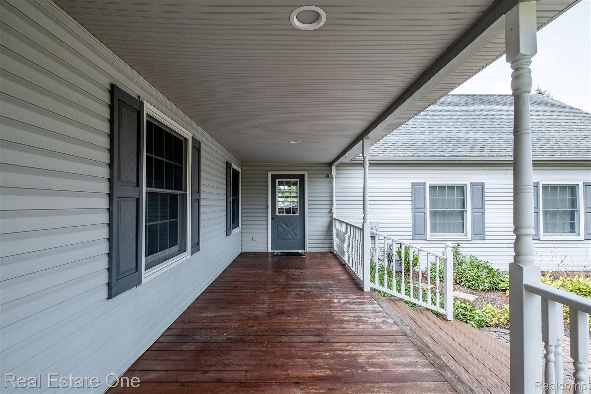 11030 Marshall Road South Lyon, MI 48178 - Photo 13 of 83 Covered front porch featuring wood-finish flooring, white railing, and siding exterior