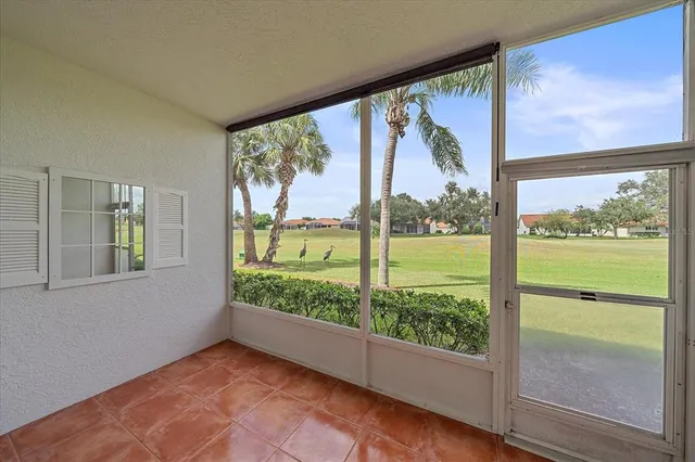 wooden floor in an empty room with a large window