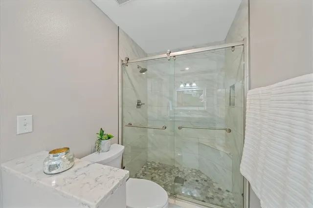 a bathroom with a shower and a sink