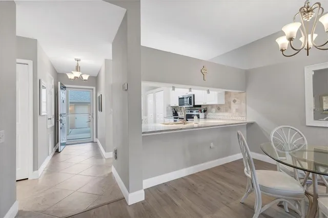 a kitchen with granite countertop a refrigerator a stove a sink and cabinets