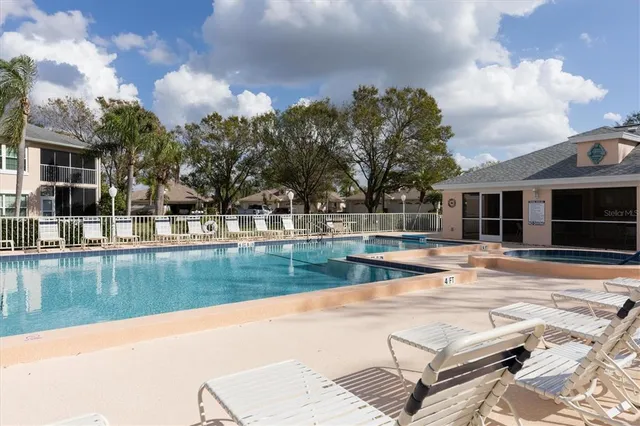 a view of a house with swimming pool and sitting area