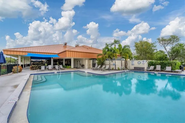 a view of swimming pool with sitting area