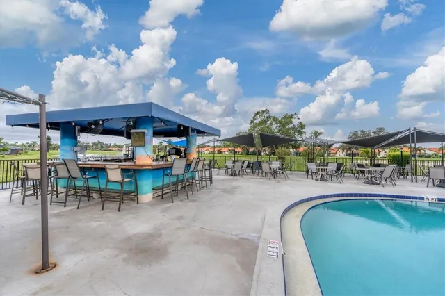 a view of swimming pool with outdoor seating
