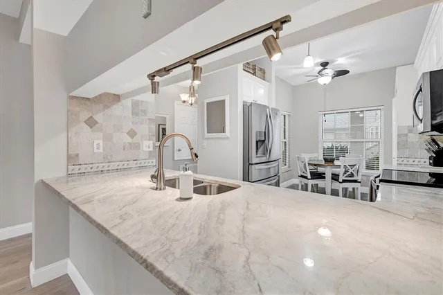 a bathroom with a sink a chandelier and a large mirror