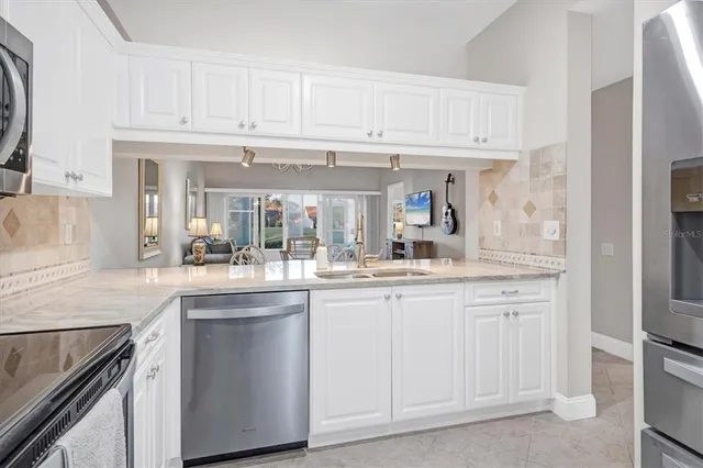 a kitchen with white cabinets and a sink