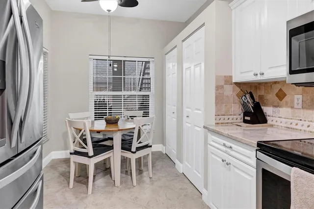 a kitchen with stainless steel appliances white cabinets and a stove