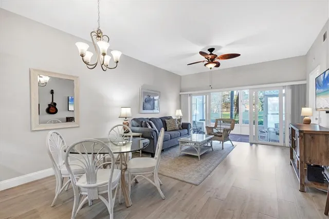 a view of a dining room with furniture wooden floor and chandelier