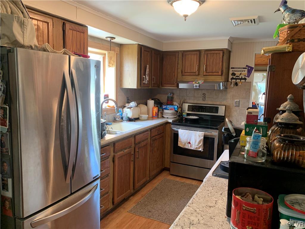 542 Norman Road Nazareth, PA 18064 - Photo 8 of 23 a kitchen with stainless steel appliances a refrigerator sink and cabinets