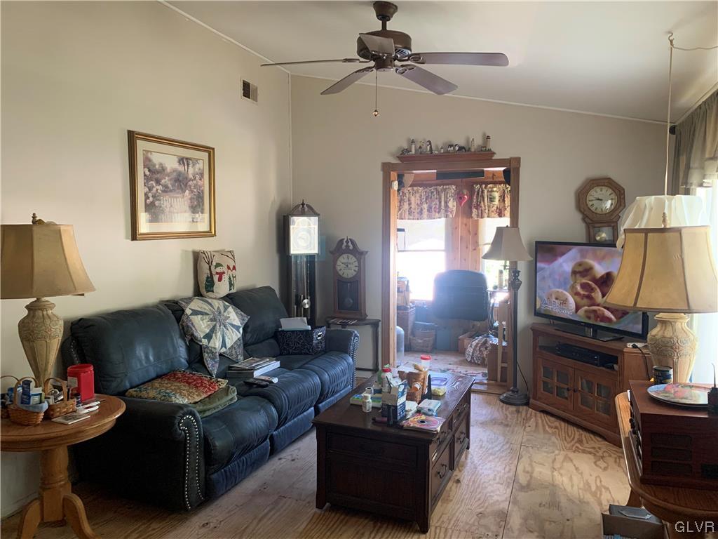 542 Norman Road Nazareth, PA 18064 - Photo 10 of 23 a living room with furniture a window and a flat screen tv