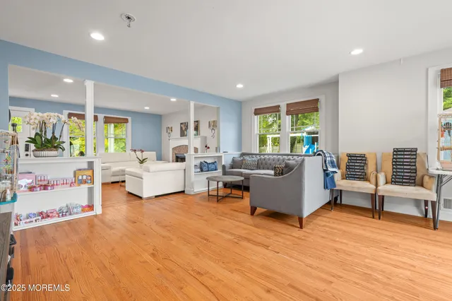 a living room with furniture and large windows